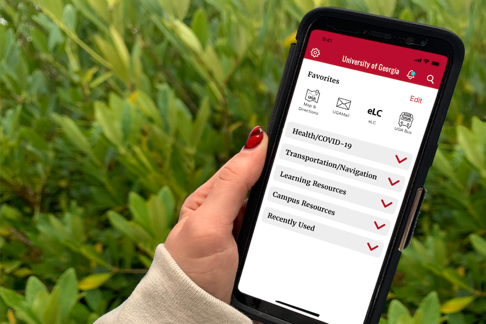 Hand holding phone with UGA mobile app