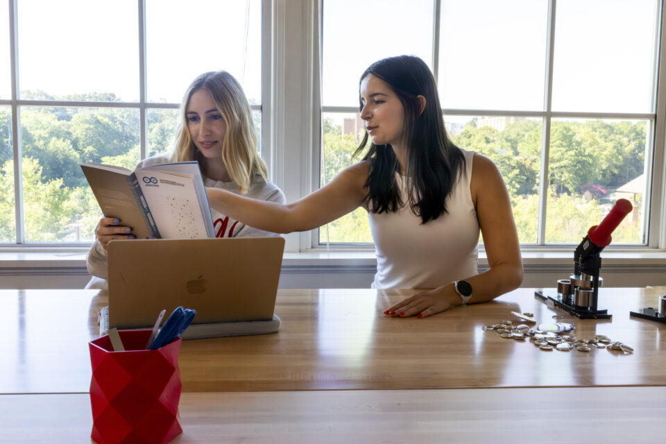 Students work at a table in the Creative Engagement wing